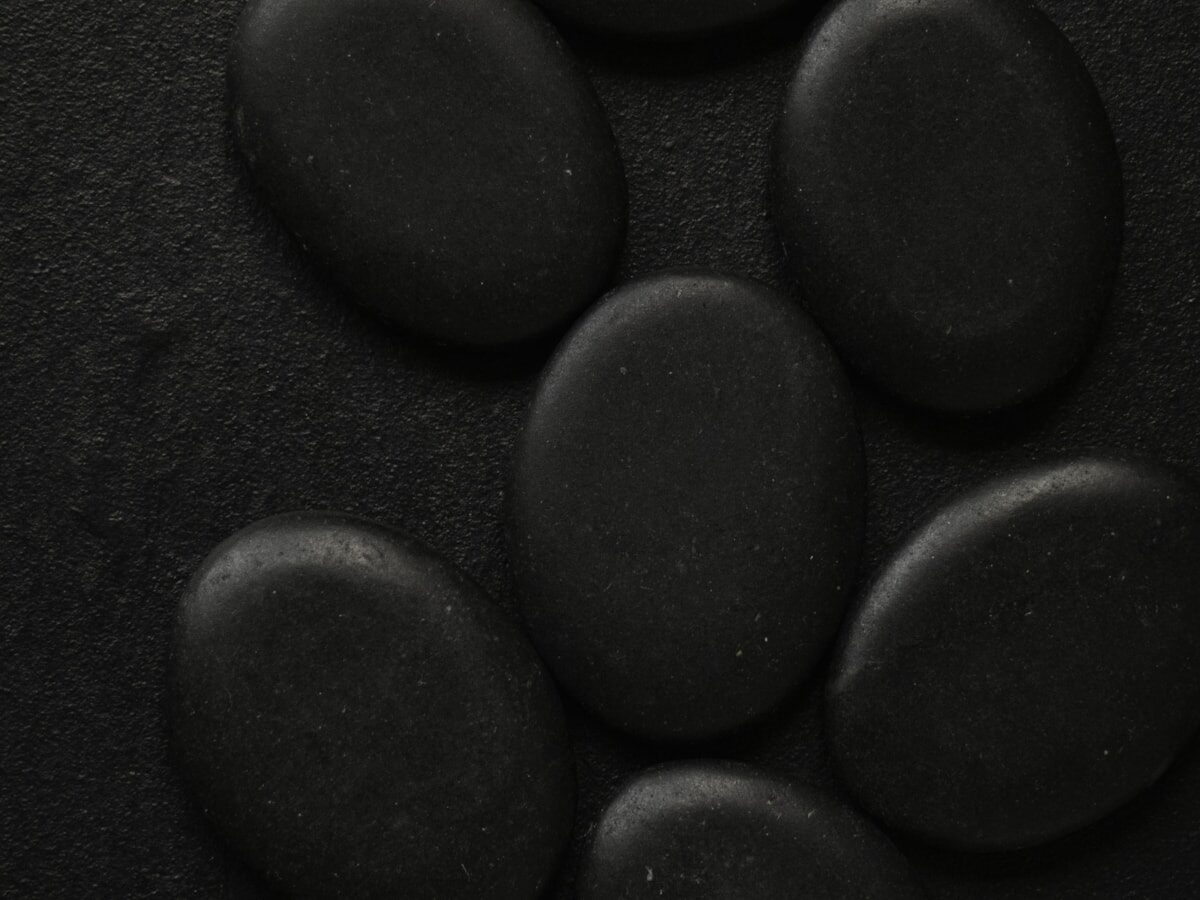 Dark volcanic lava stones that heat the private steam pod